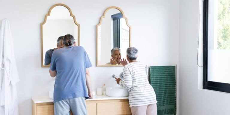 Senior Couple Getting Ready Together in Bathroom at Assisted Living Facility