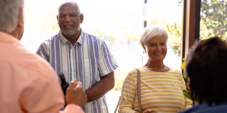 Elderly Couple Smiling While Reading Together in Independent Living