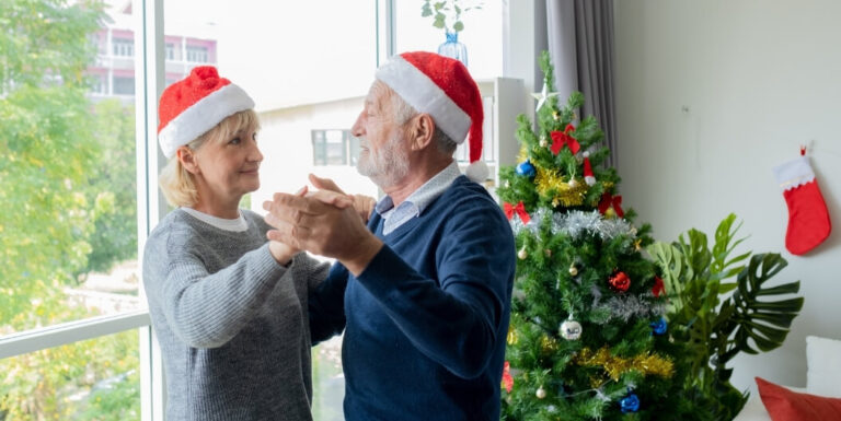 Elderly Couple Dancing by Christmas Tree in Assisted Living