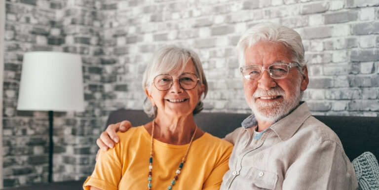 Elderly Couple Sitting Together on a Sofa at an Assisted Living Facility