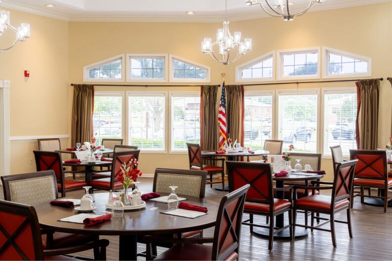 Bright Dining Room with Round Tables and Large Windows at Assisted Living Community Bright Dining Room with Round Tables and Large Windows at Assisted Living Community