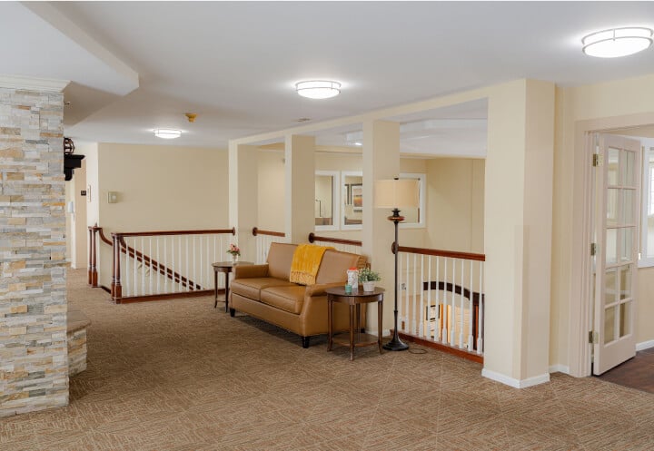 Upstairs Lobby with Leather Sofa and Staircase Railing at Assisted Living Facility Upstairs Lobby with Leather Sofa and Staircase Railing at Assisted Living Facility