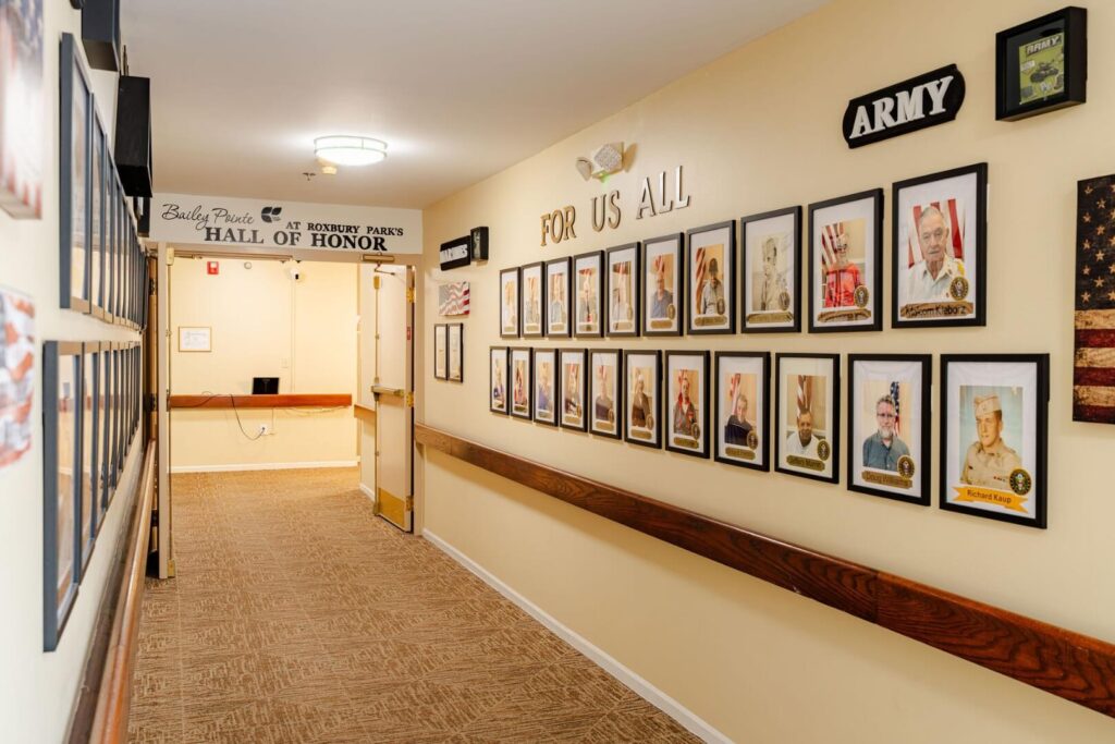 Hall of Honor Hallway Displaying Veteran Portraits in Assisted Living