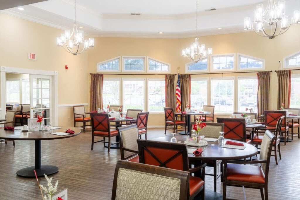 Spacious Dining Area with Chandeliers and Set Tables for Elderly Assisted Living Care