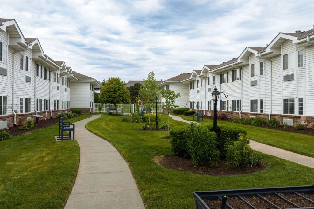 Winding Walkway with Benches and Landscaped Garden in Assisted Living