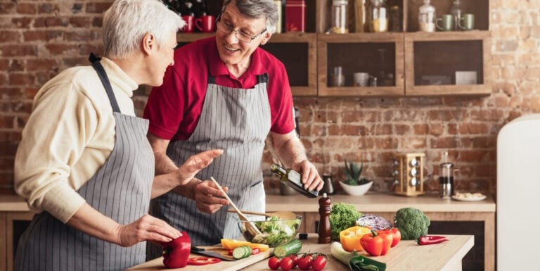 Elderly Couple Preparing a Healthy Vegetable Salad Together at Assisted Living Facility