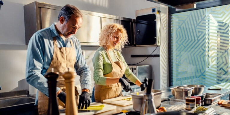 Elderly Couple Cooking Together in Modern Kitchen at Assisted Living Facility