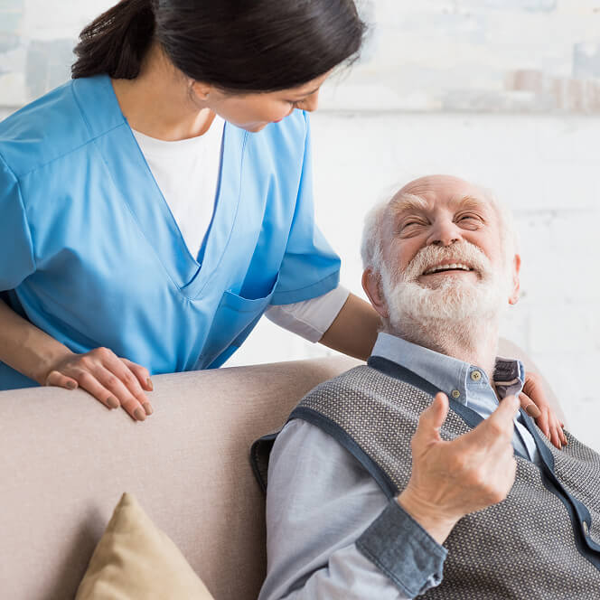 Caregiver Comforting Resident at Memory Care Facility